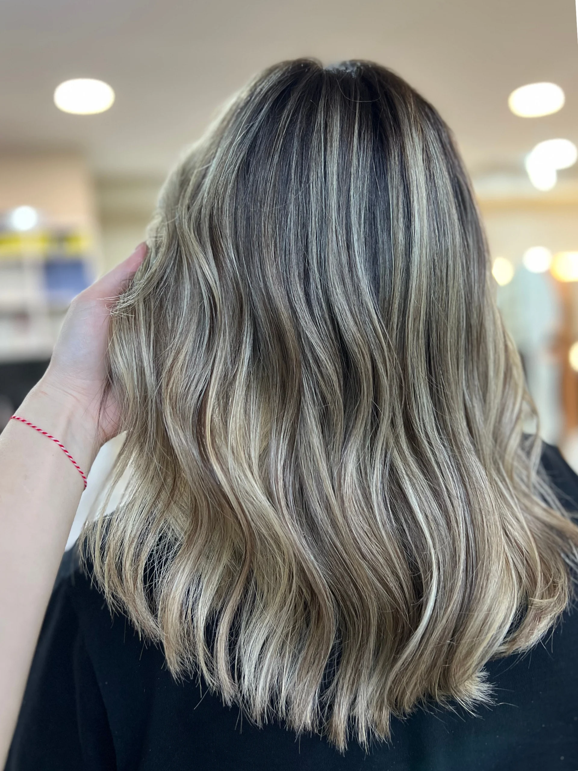 Wavy ash-blonde balayage colour by Ela Beauty Salon