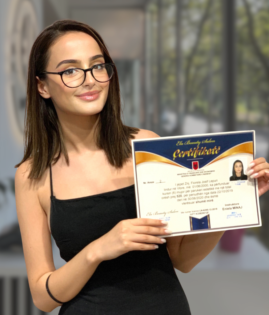 Academy graduate holding her completion certificate
