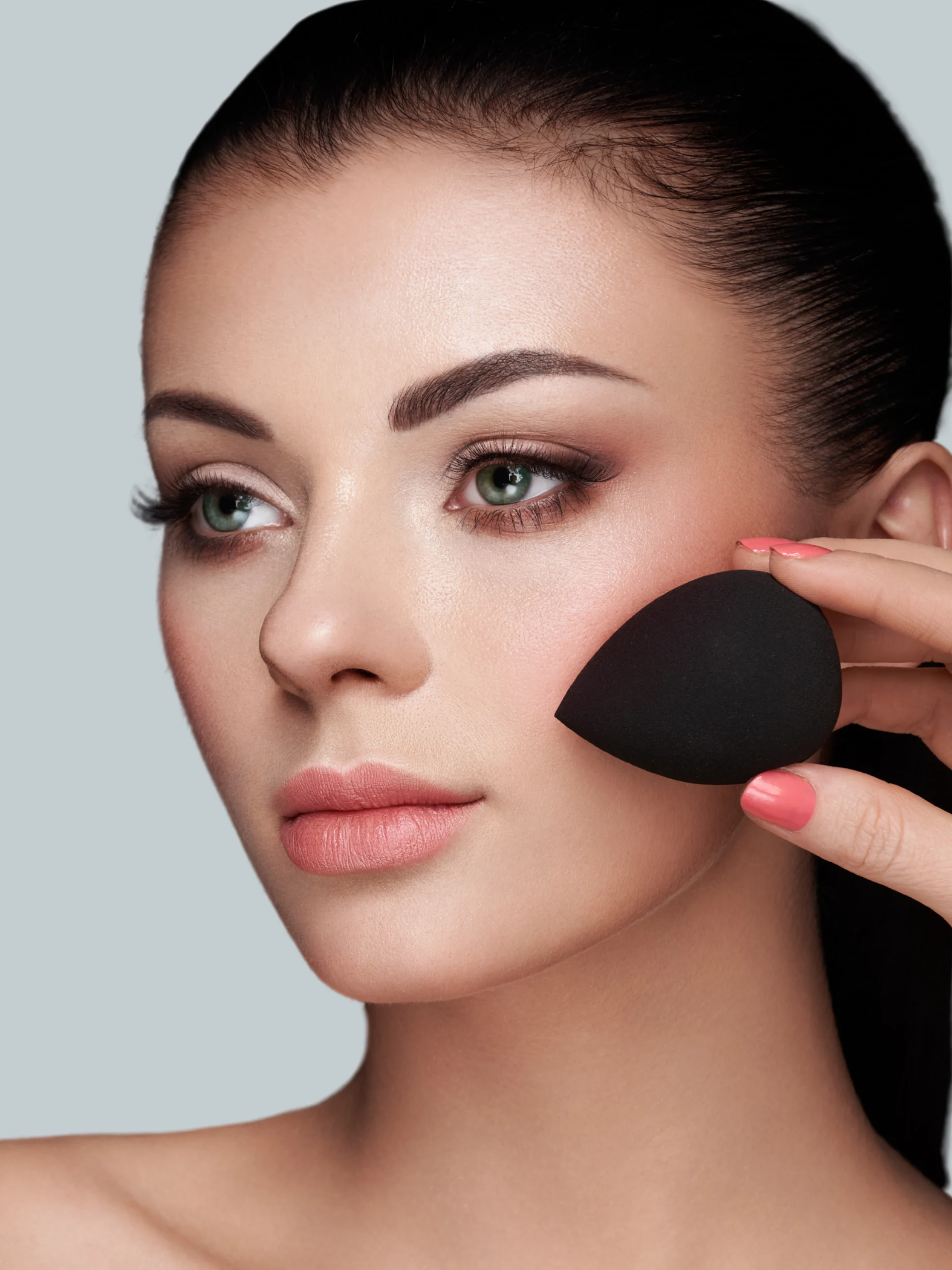 Makeup artist blending foundation on a client's cheek