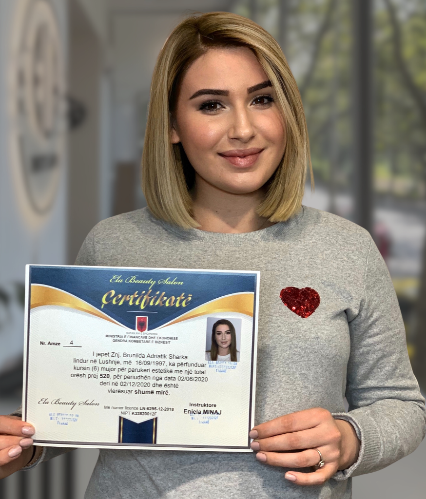 Academy graduate holding her completion certificate